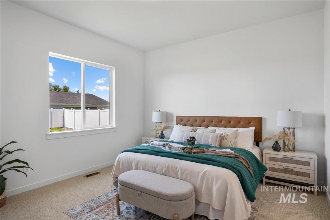Carpeted bedroom with baseboards