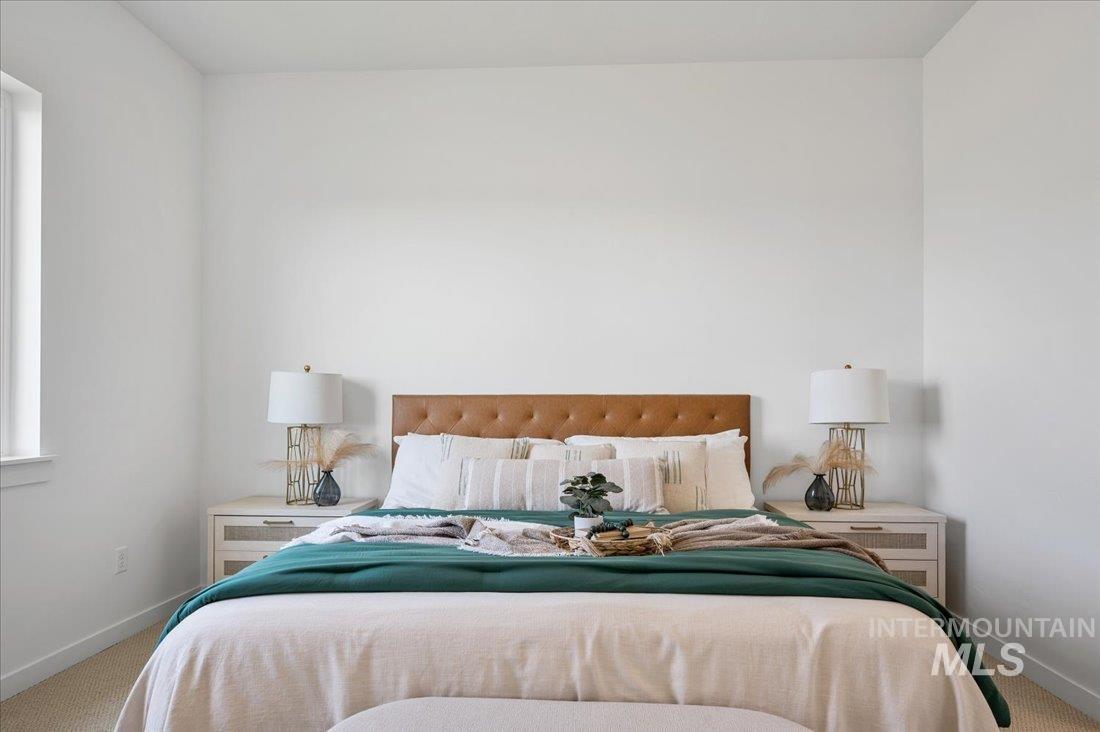 Carpeted bedroom with baseboards