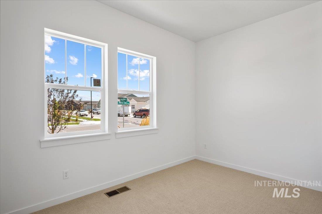 Empty room featuring carpet floors and baseboards