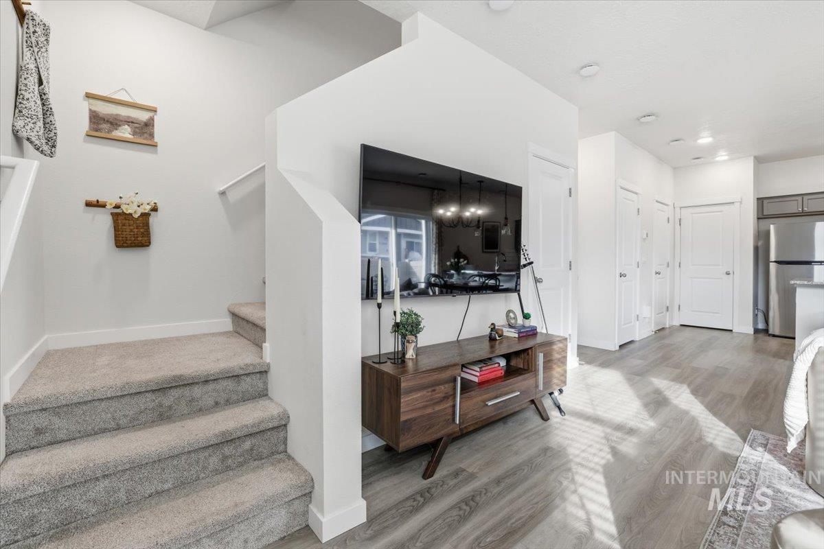 Stairway featuring wood finished floors and baseboards