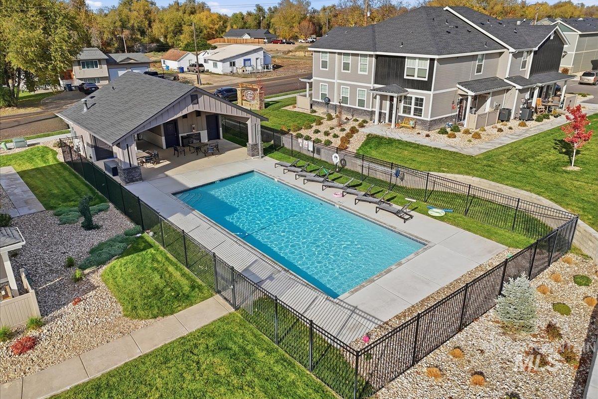 Community pool featuring a patio and a residential view