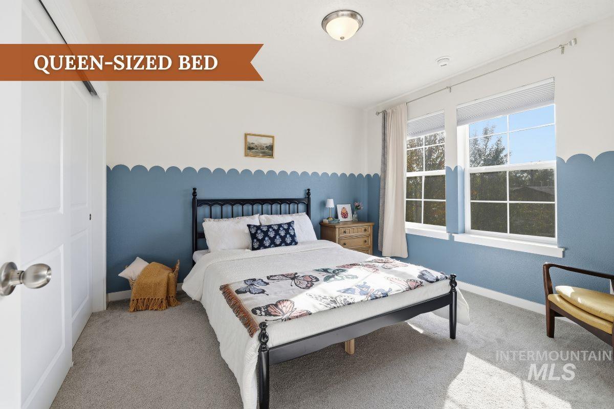 Carpeted bedroom with baseboards and a closet