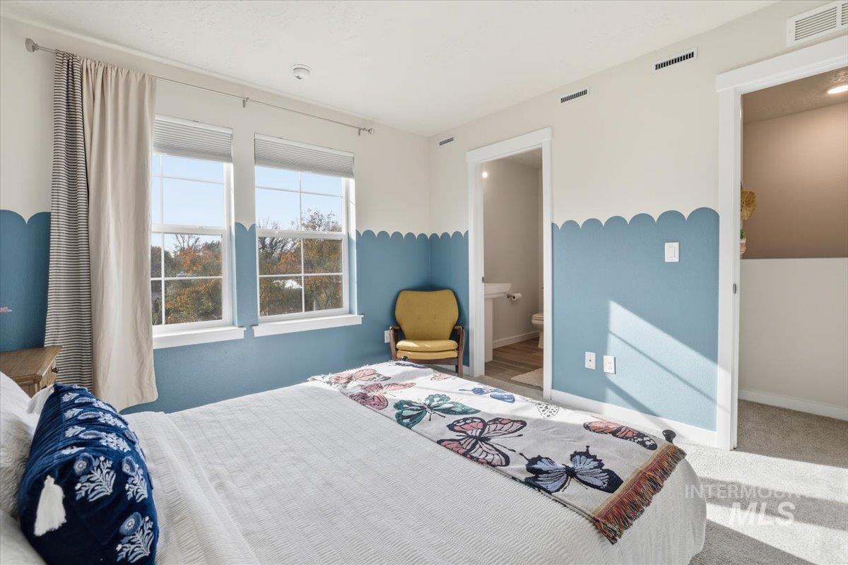 Bedroom featuring carpet floors and ensuite bath