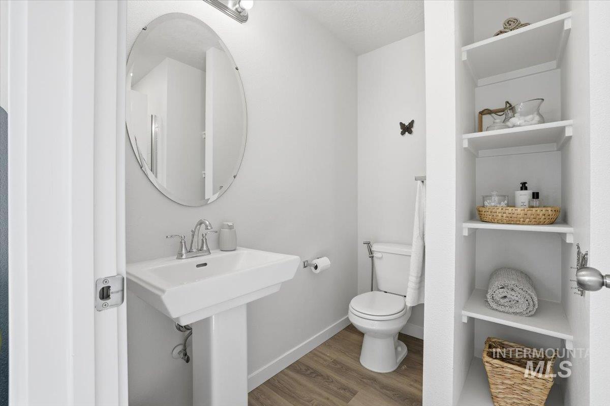Bathroom with wood finished floors, built in features, and a textured ceiling