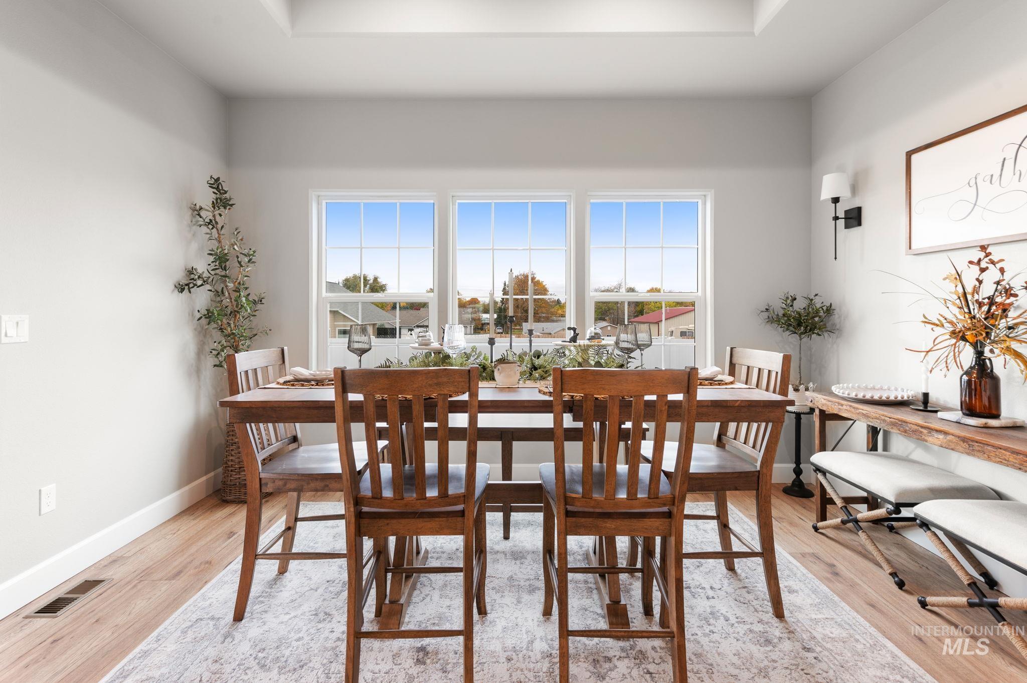 Dining area with healthy amount of natural light and light wood finished floors