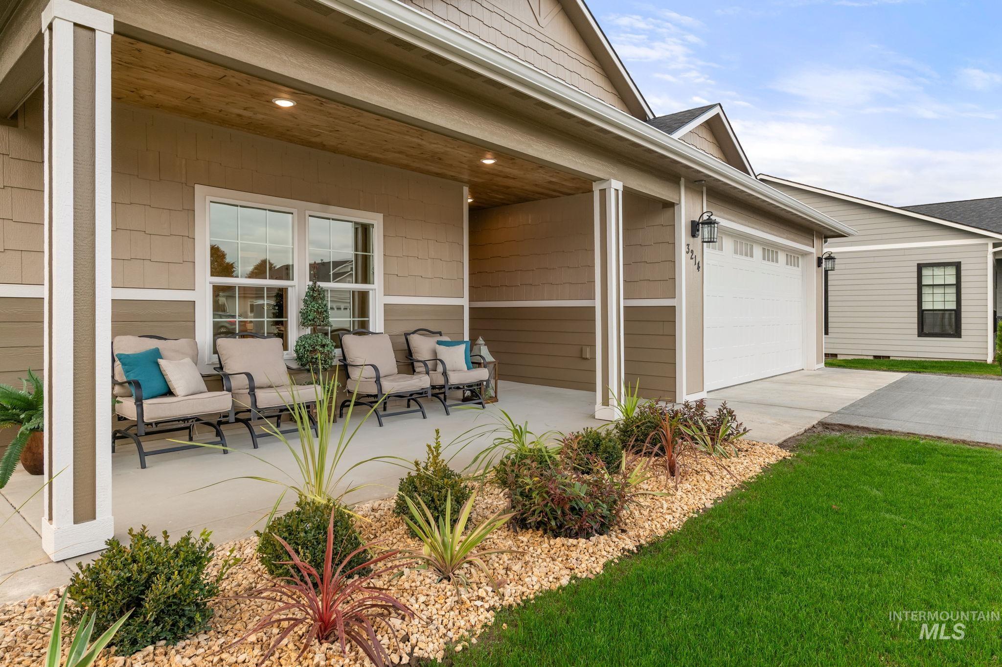 View of patio with a garage and concrete driveway