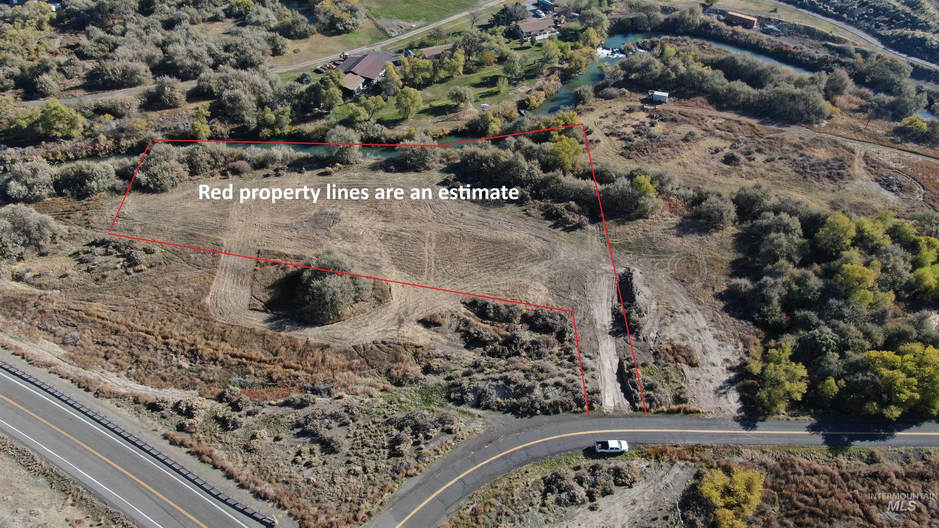 Aerial view of sparsely populated area with property parcel outlined
