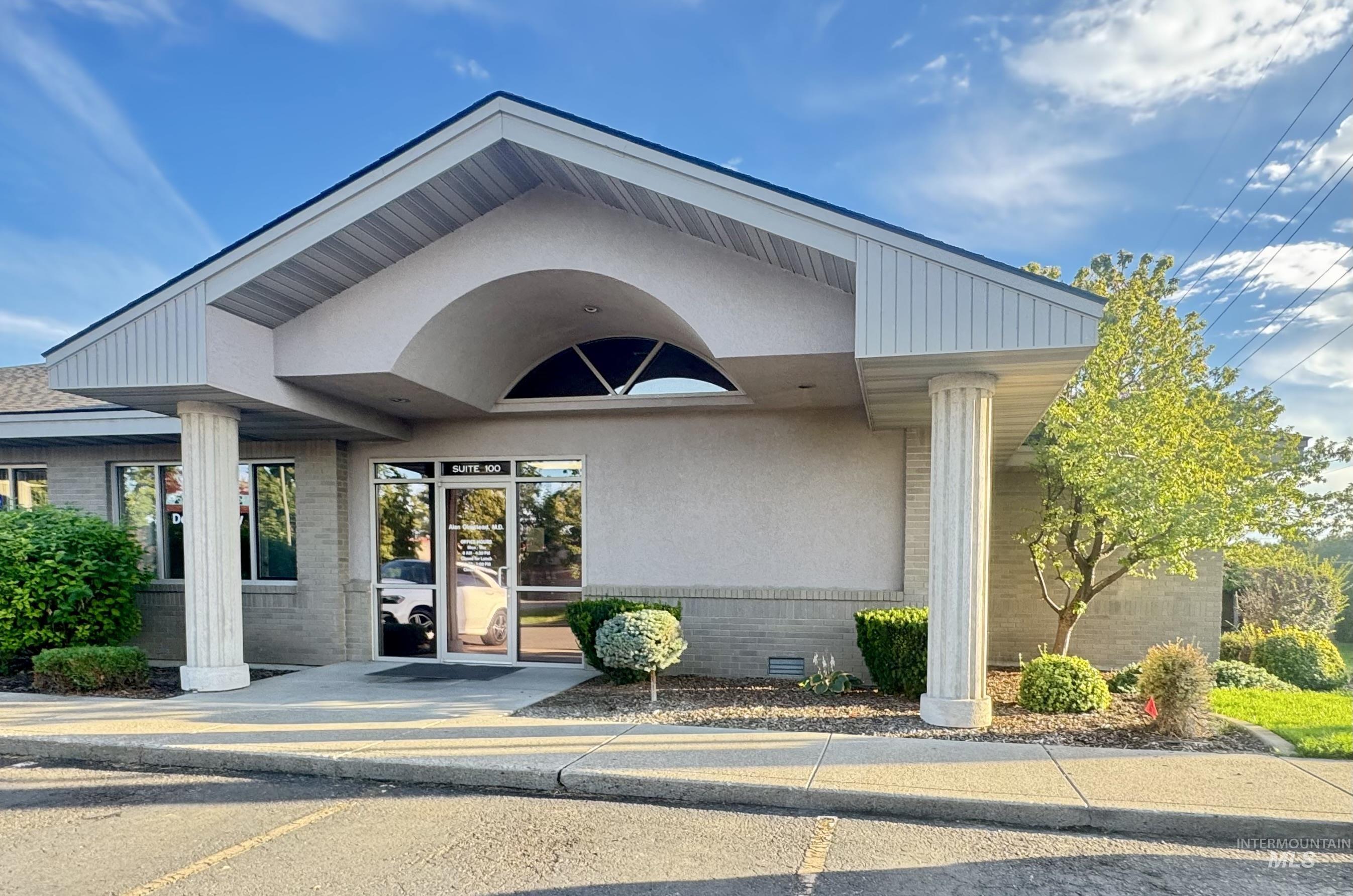 View of exterior entry featuring crawl space and brick siding