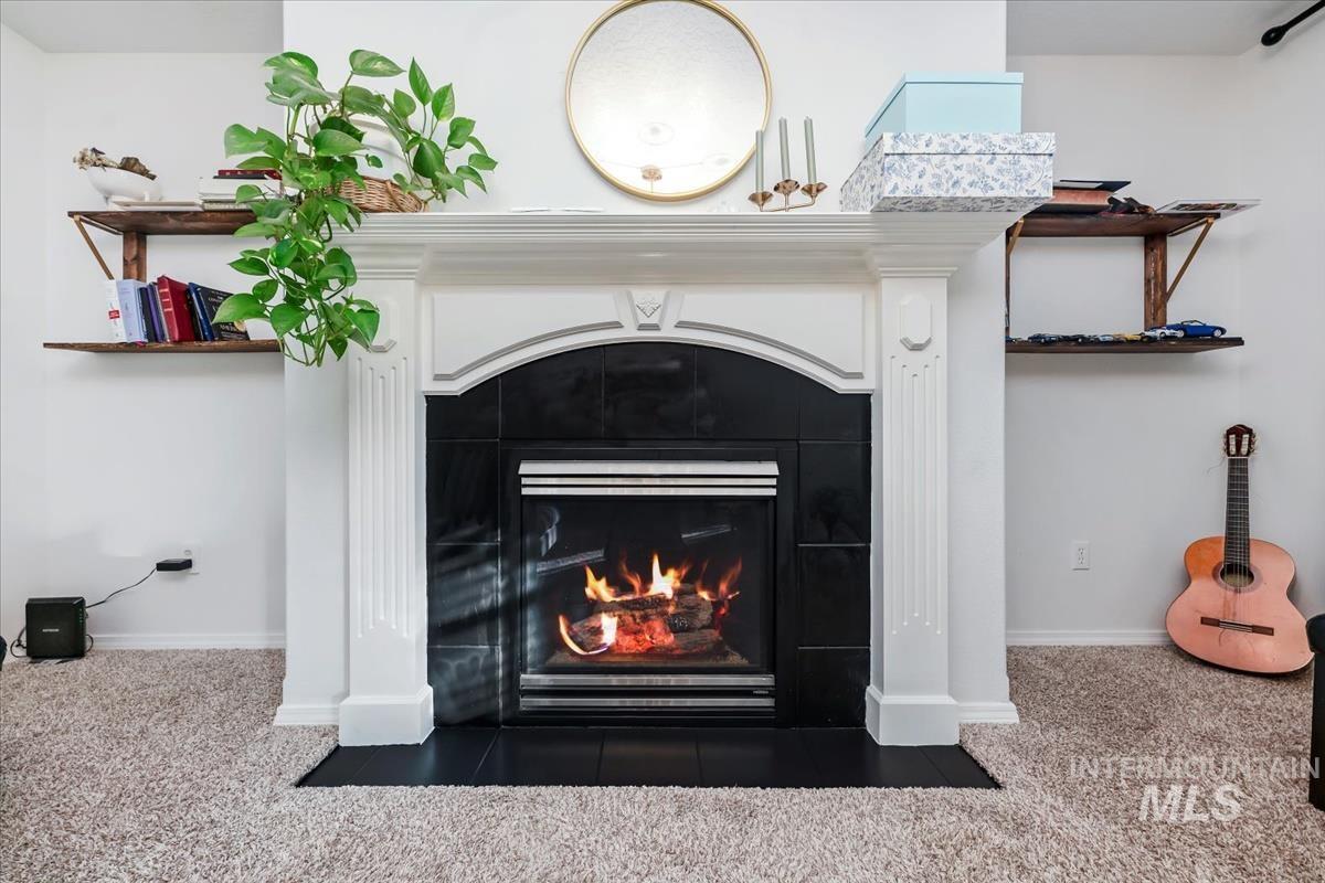 Detailed view of carpet floors and a tile fireplace