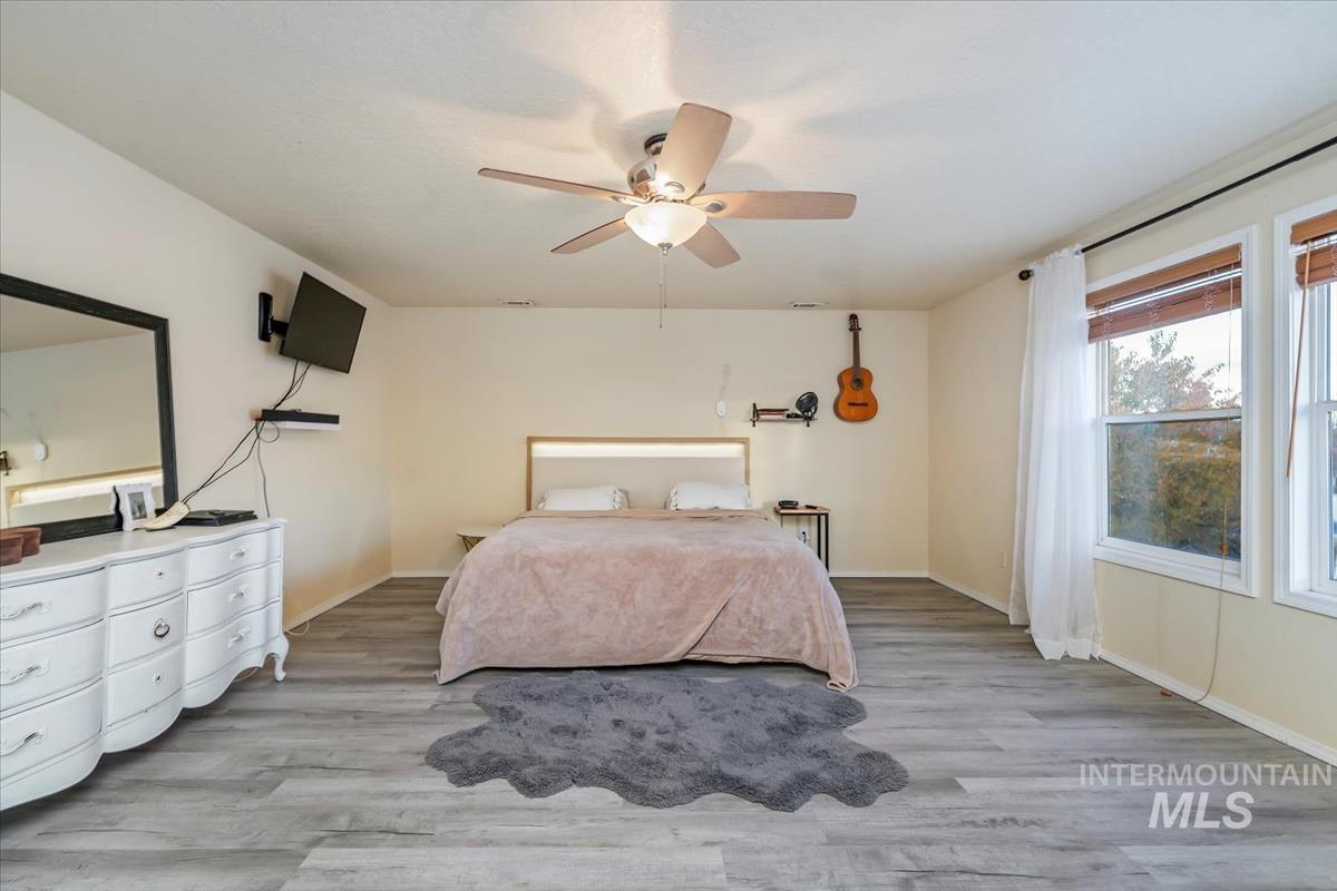 Bedroom featuring light wood finished floors and a ceiling fan