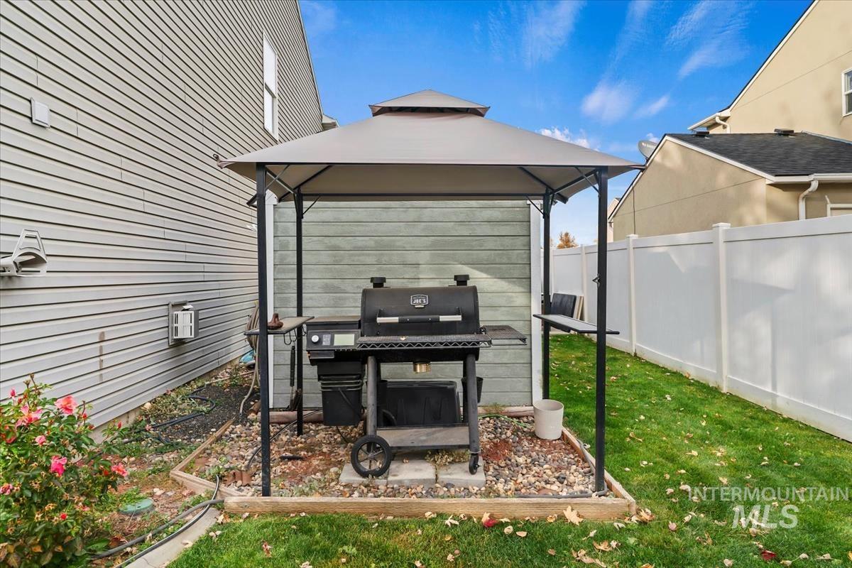 View of patio / terrace with a gazebo, pet washing station, and a grill