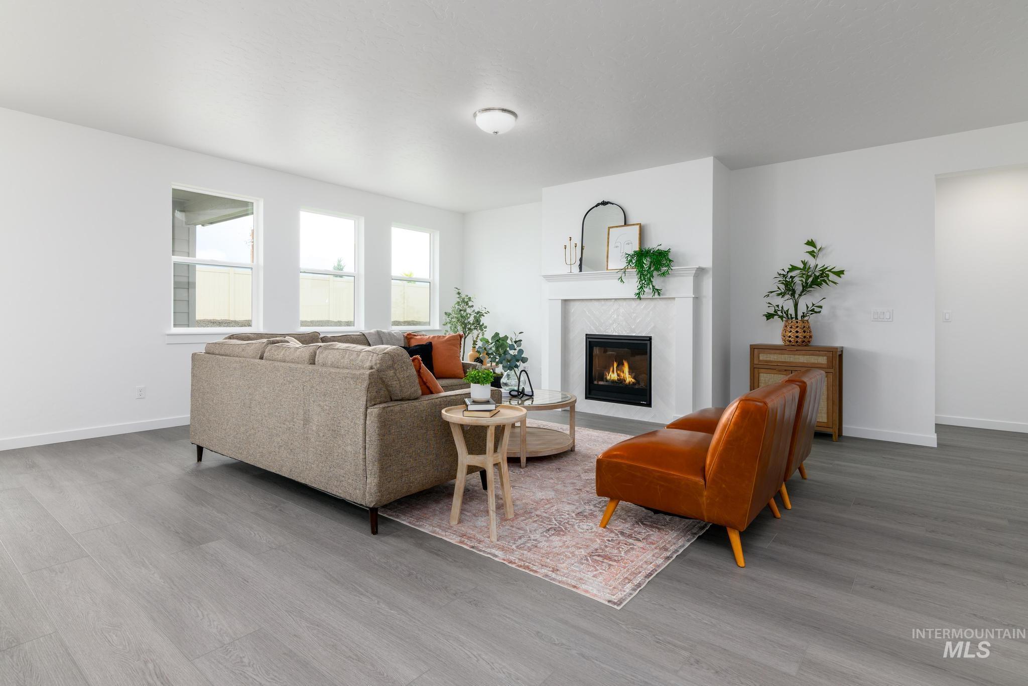 Living area featuring a premium fireplace and light wood-style flooring