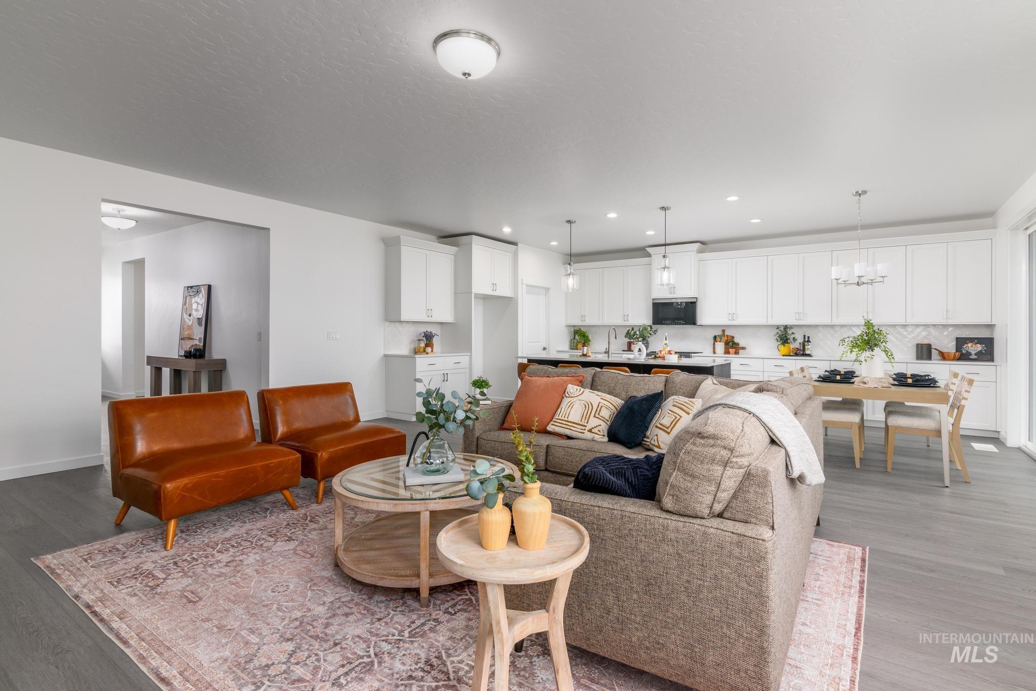 Living area with light wood-style floors, recessed lighting, and a chandelier