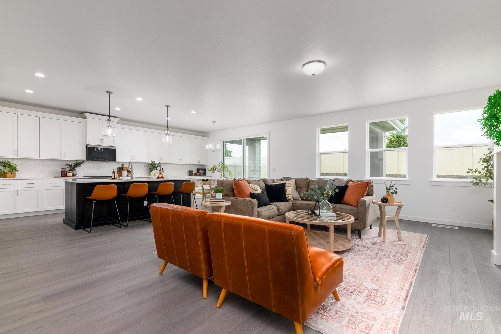 Living area with light wood-style floors, plenty of natural light, and recessed lighting