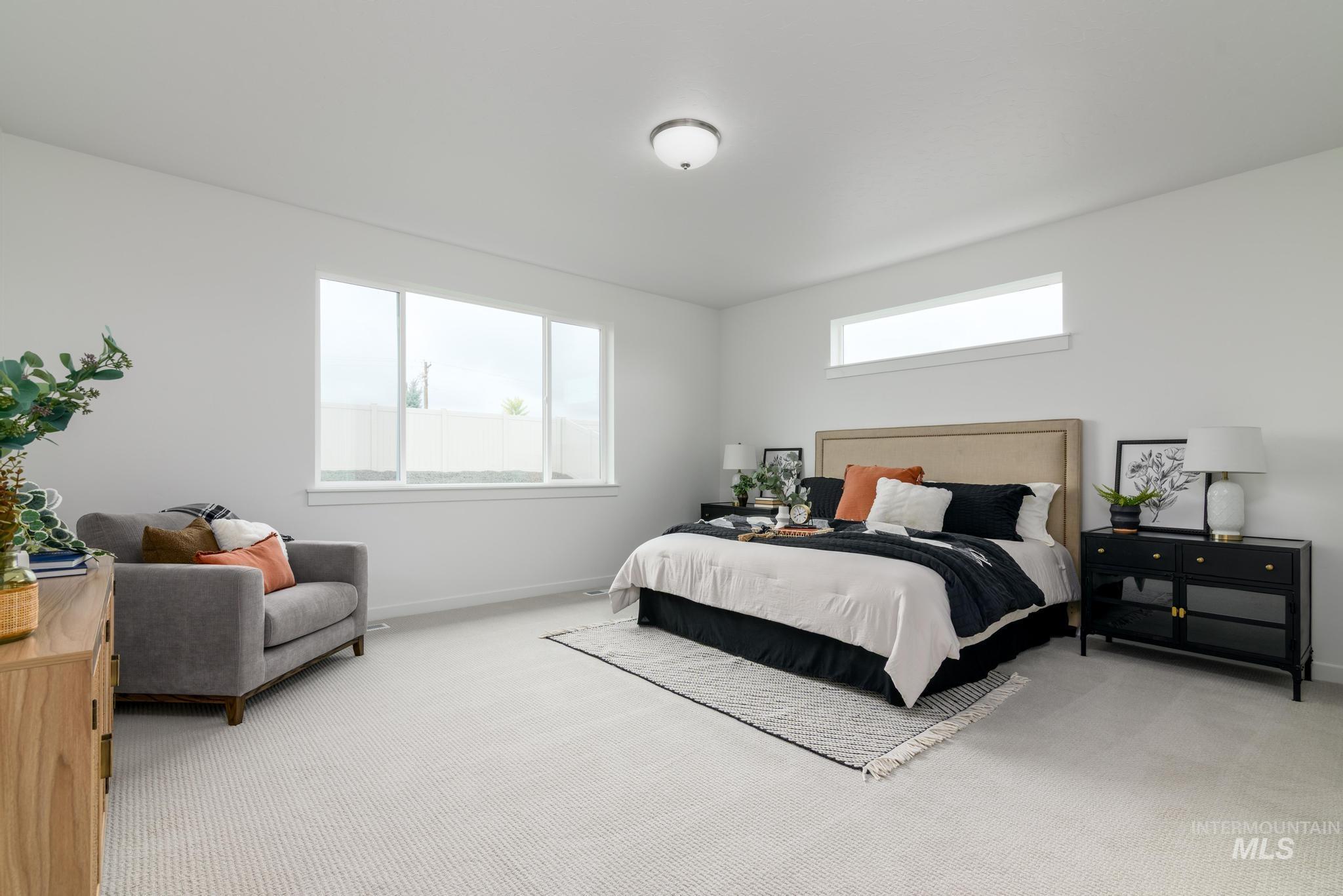 Carpeted bedroom featuring baseboards