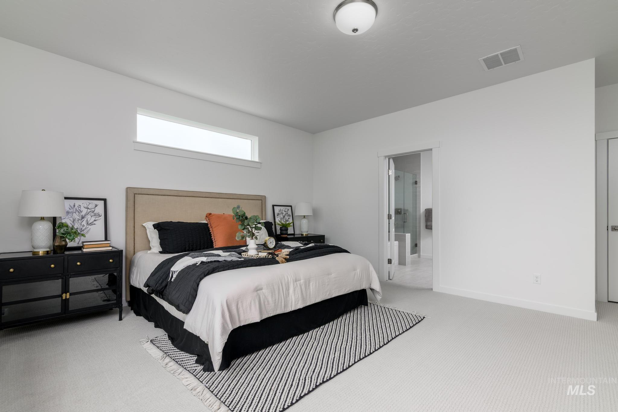 Carpeted bedroom featuring baseboards