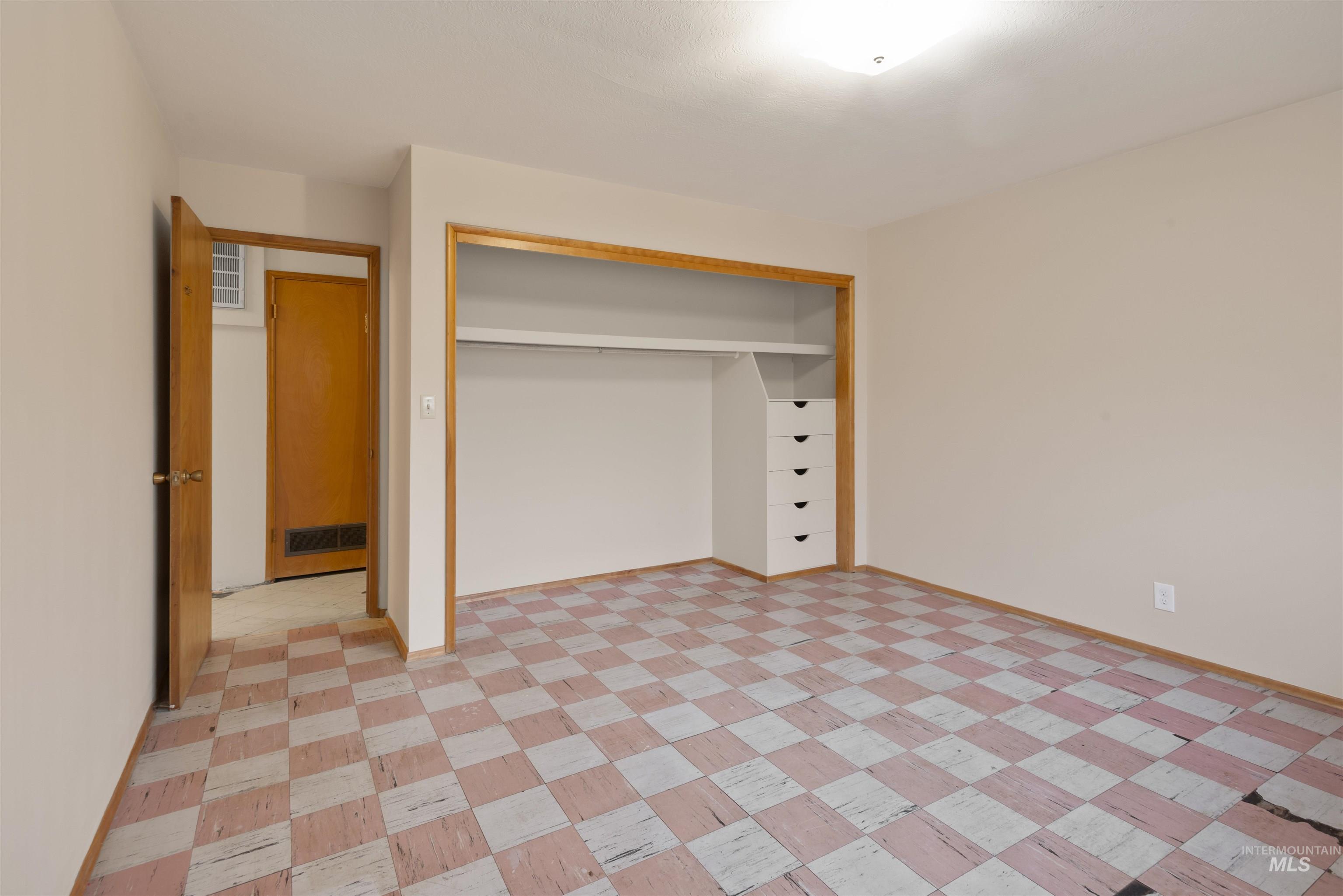 Unfurnished bedroom with a closet and light flooring