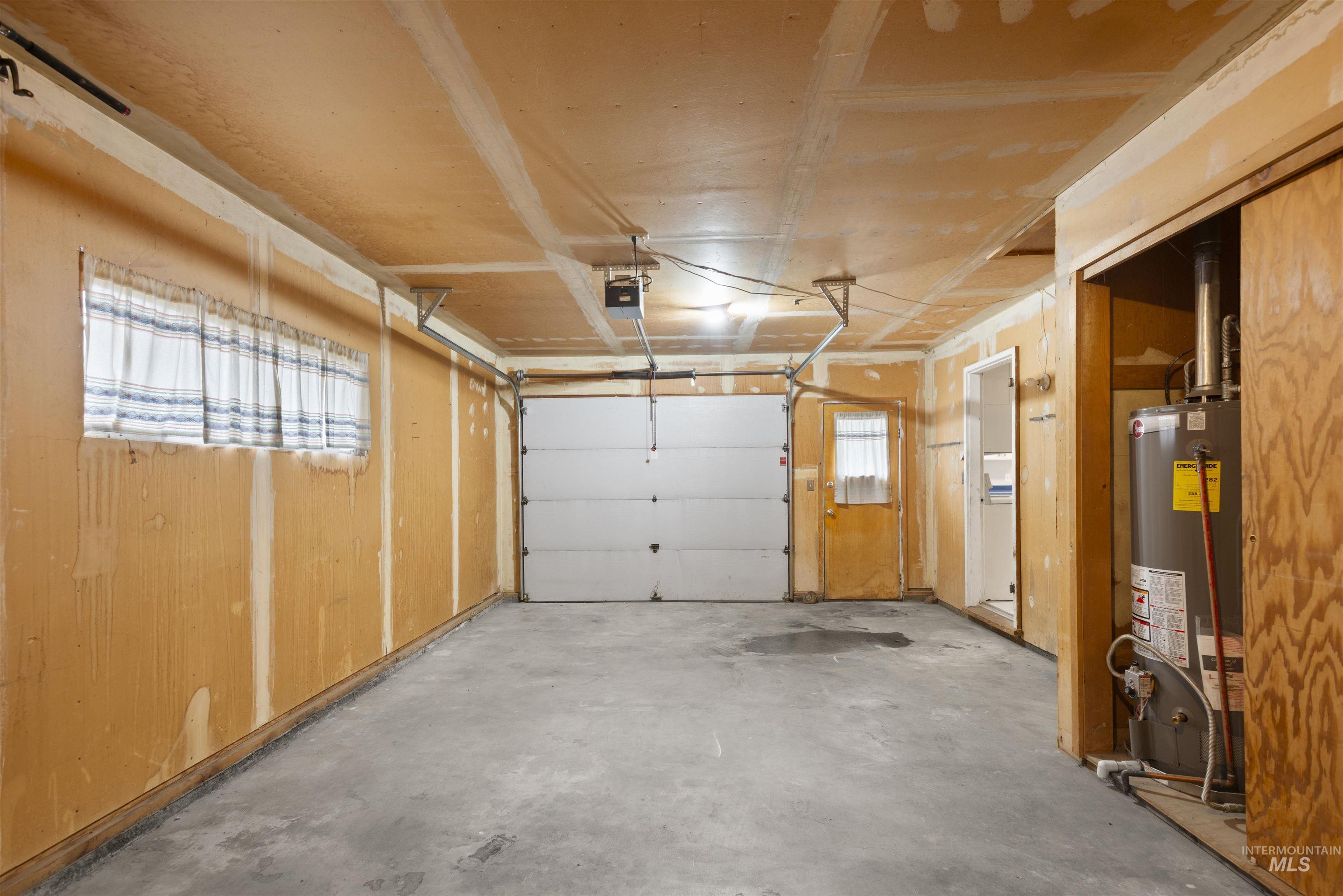 Garage with water heater and a garage door opener