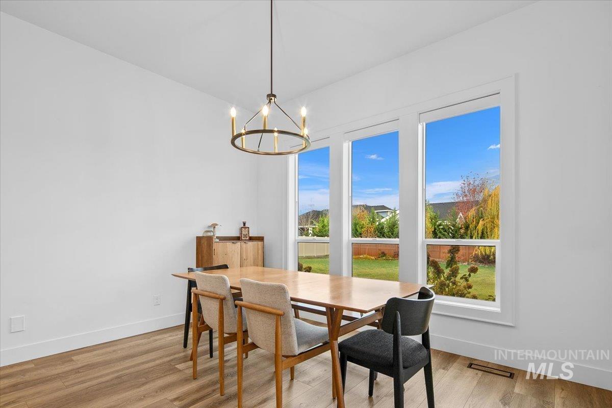 Dining area with light wood-style flooring and a chandelier
