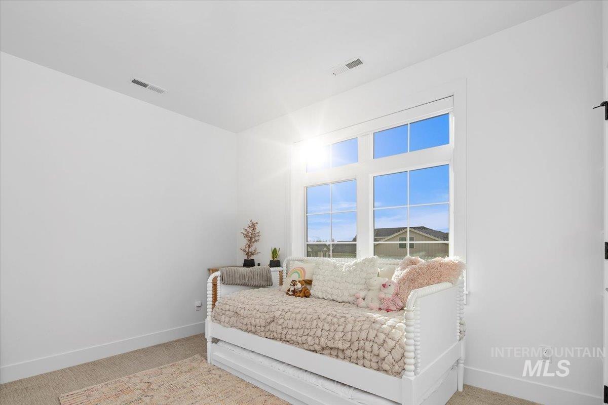 Bedroom with light carpet