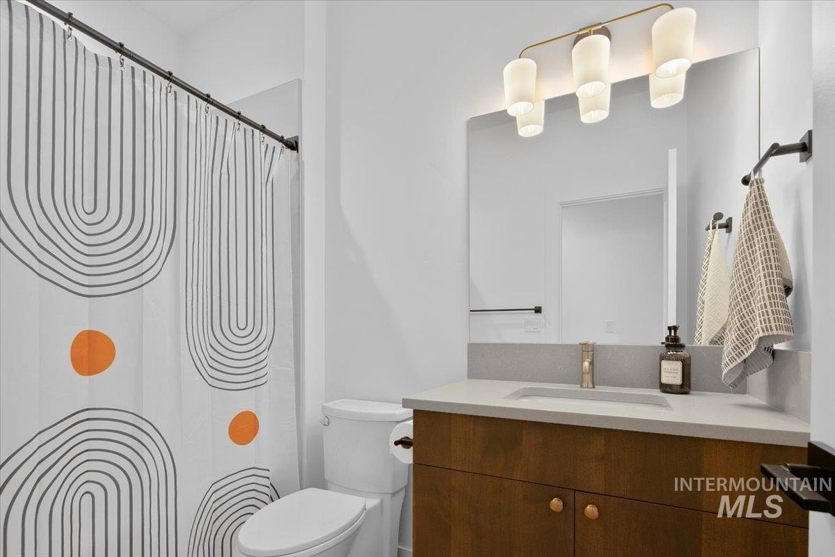 Full bath featuring vanity and a shower with shower curtain