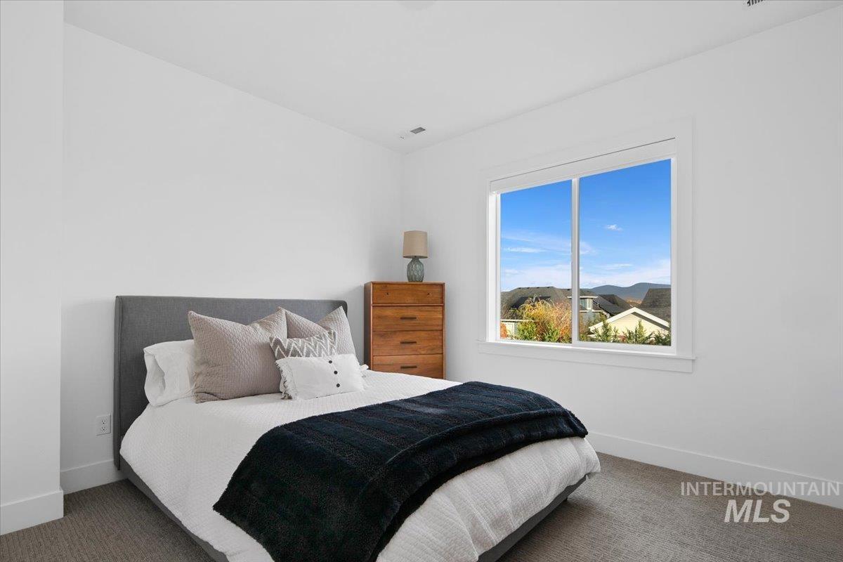Carpeted bedroom featuring baseboards