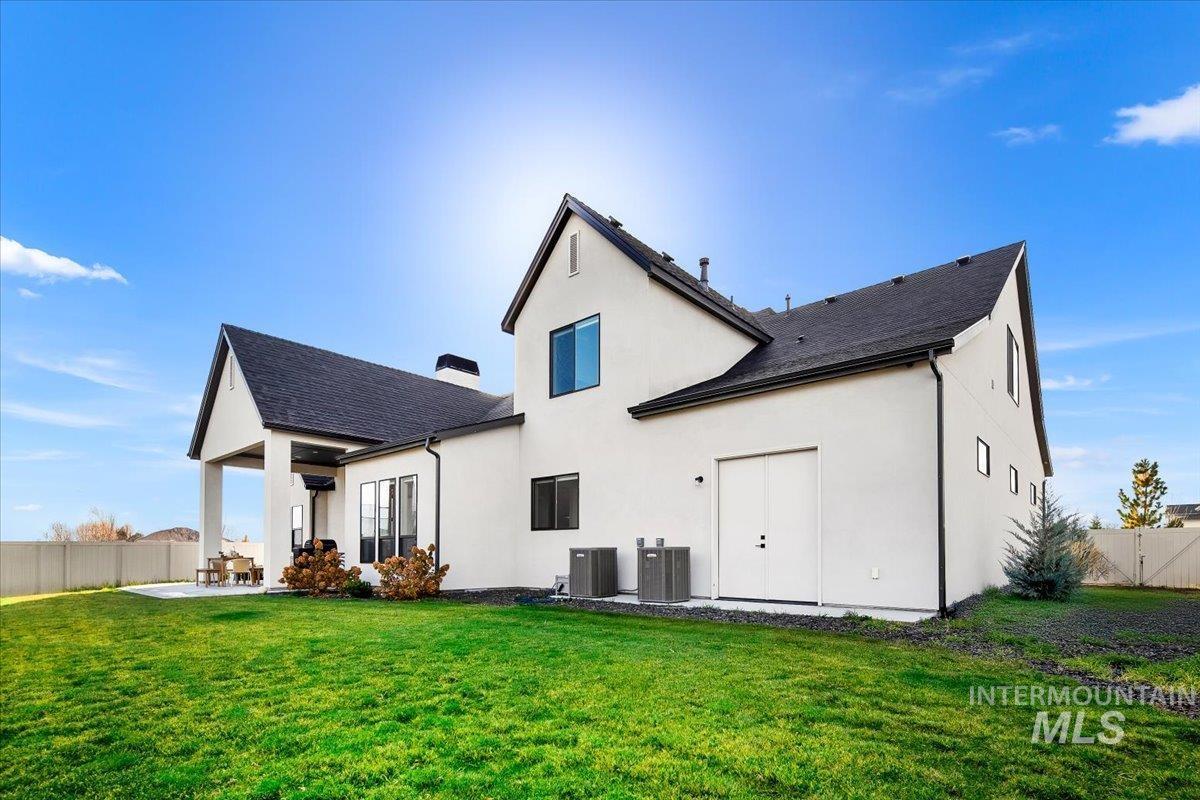 Back of house with a fenced backyard, a patio, stucco siding, and a shingled roof