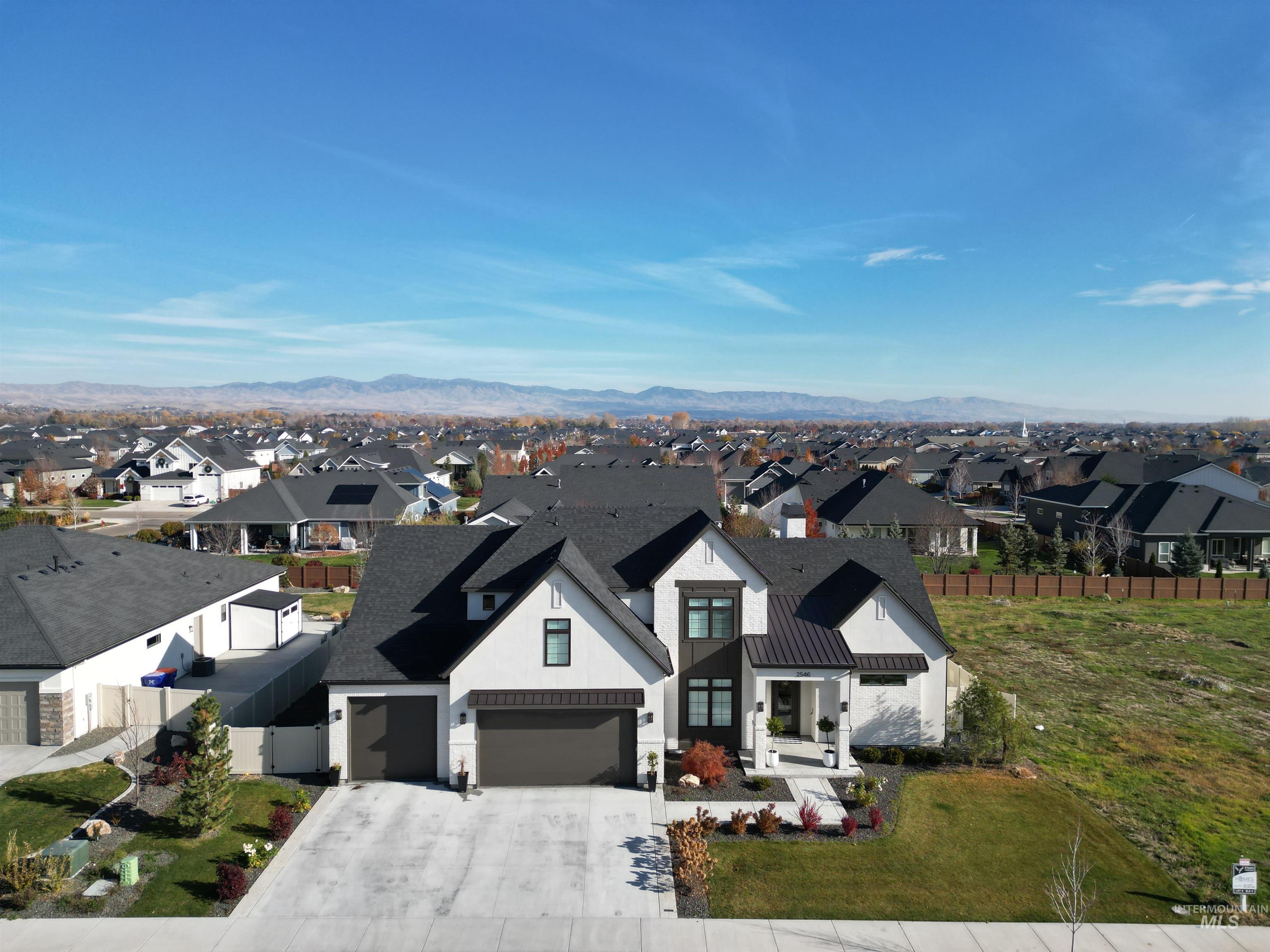 Aerial view of residential area featuring mountains