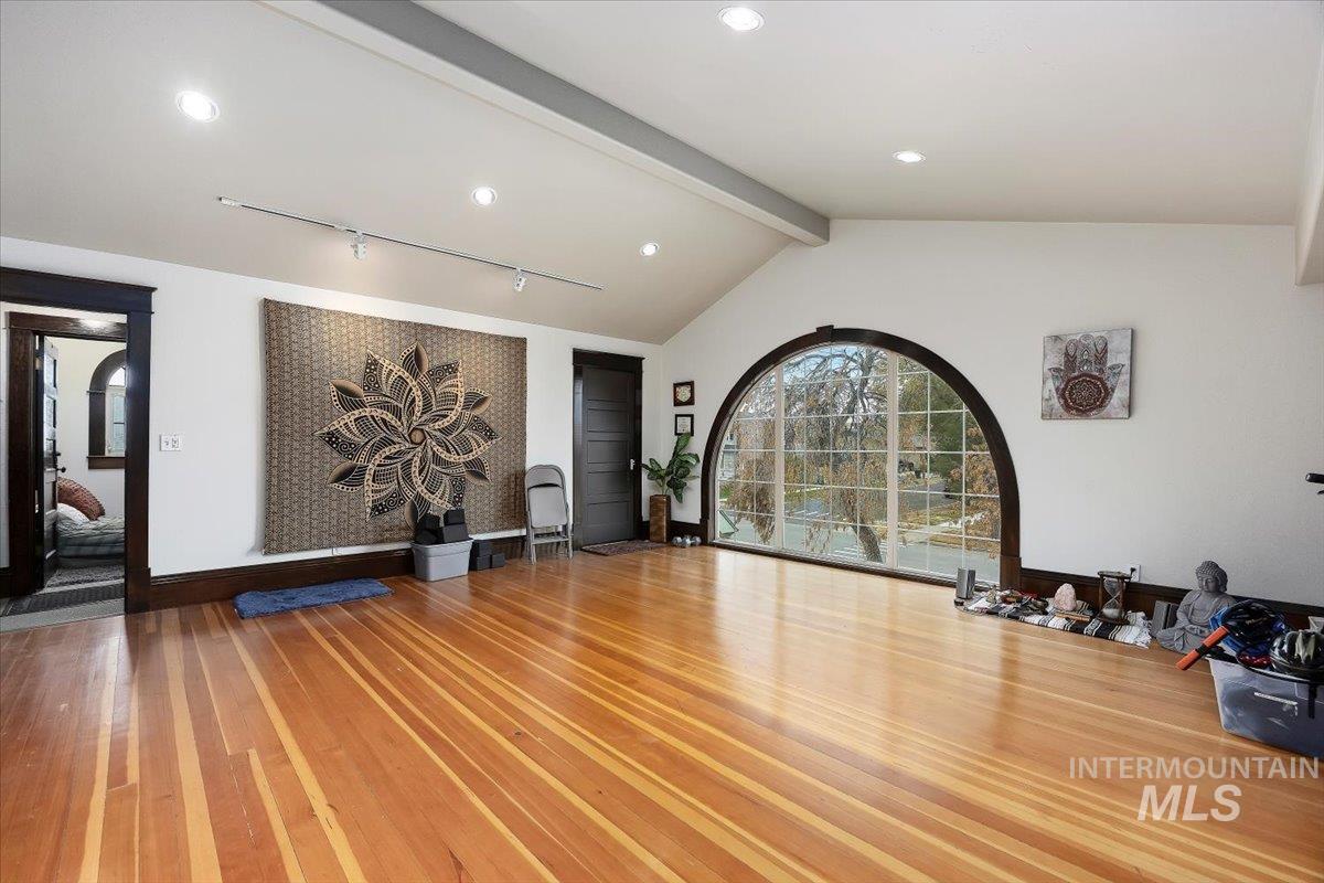 Workout area with hardwood / wood-style flooring and recessed lighting