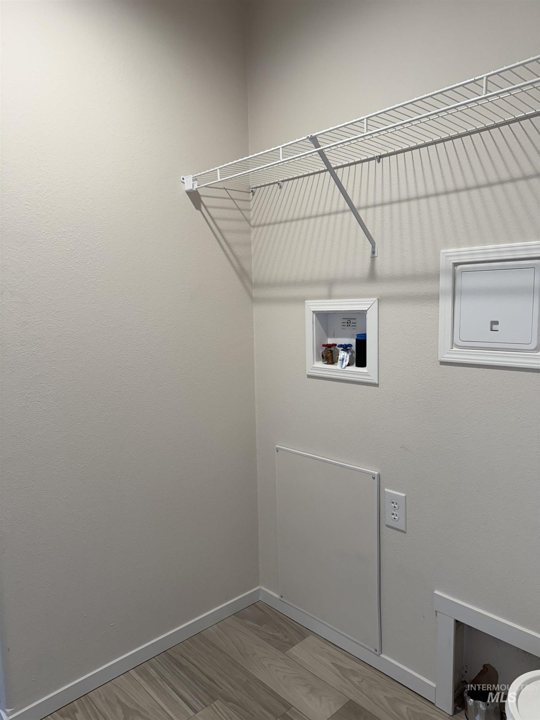 Washroom featuring light wood-style floors and washer hookup