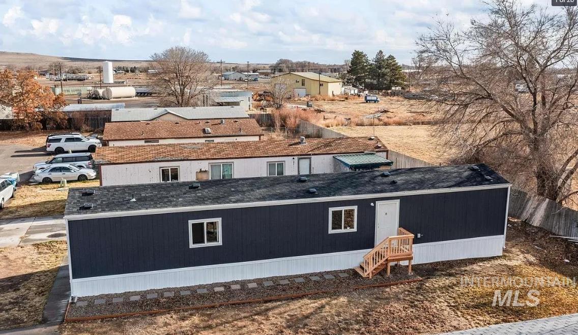 View of home's exterior with a residential view and a shingled roof