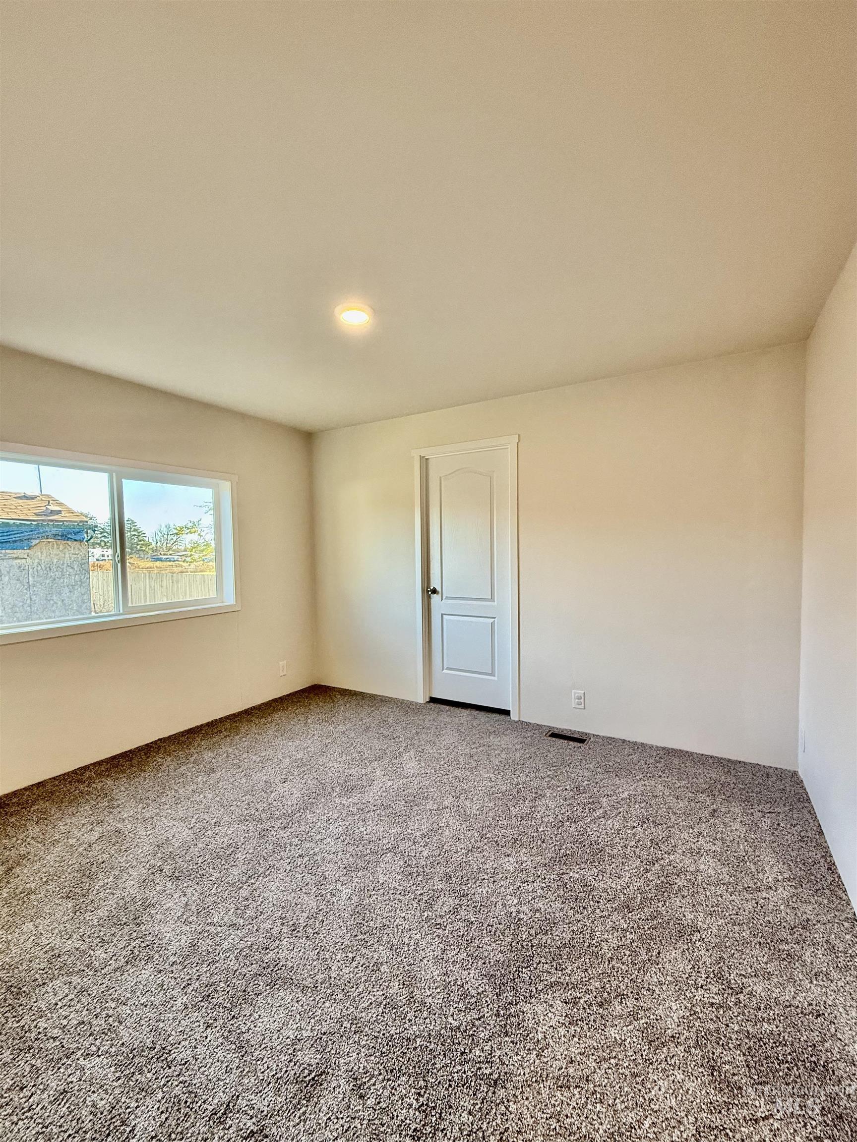 Empty room with carpet flooring