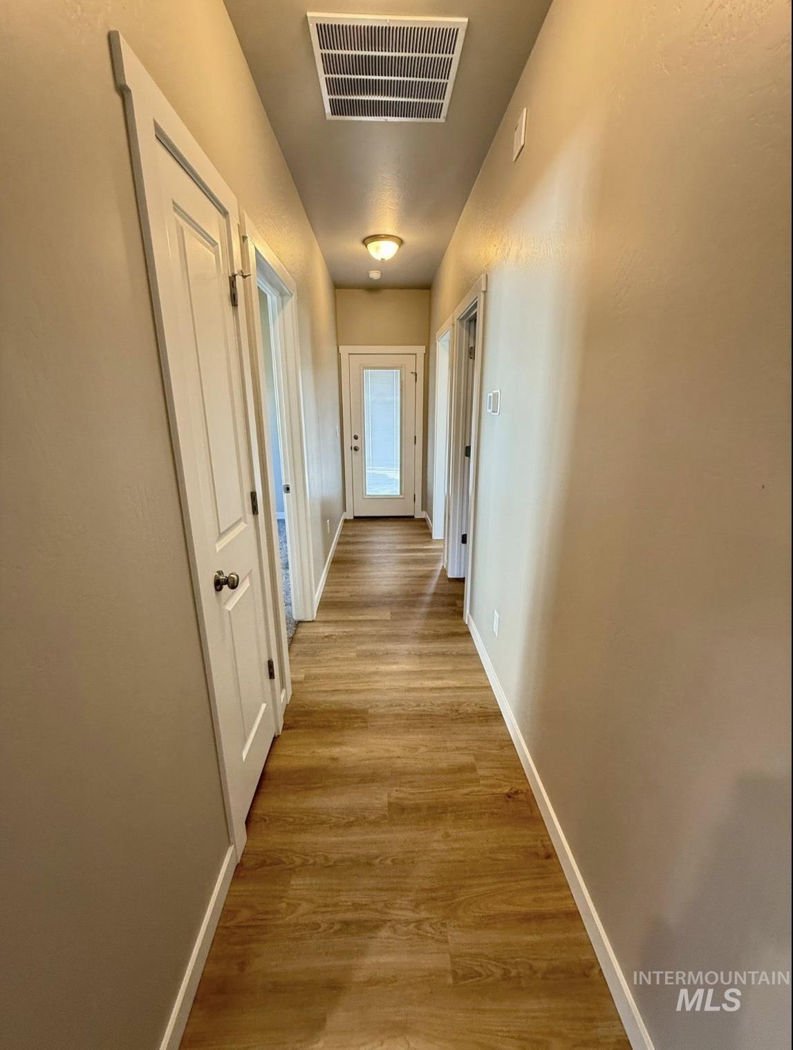 Hall featuring light wood-style floors