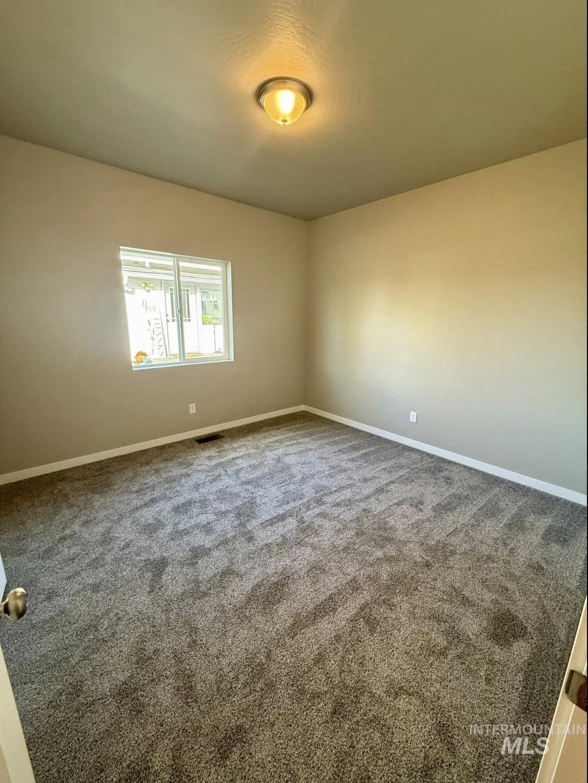 Empty room featuring carpet