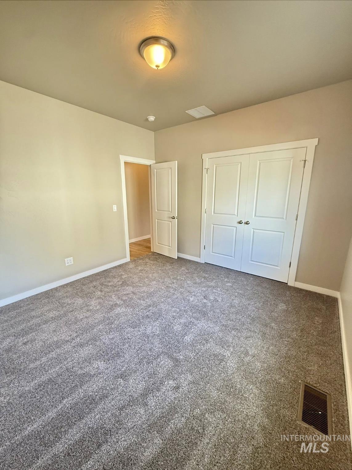 Unfurnished bedroom featuring carpet floors and a closet