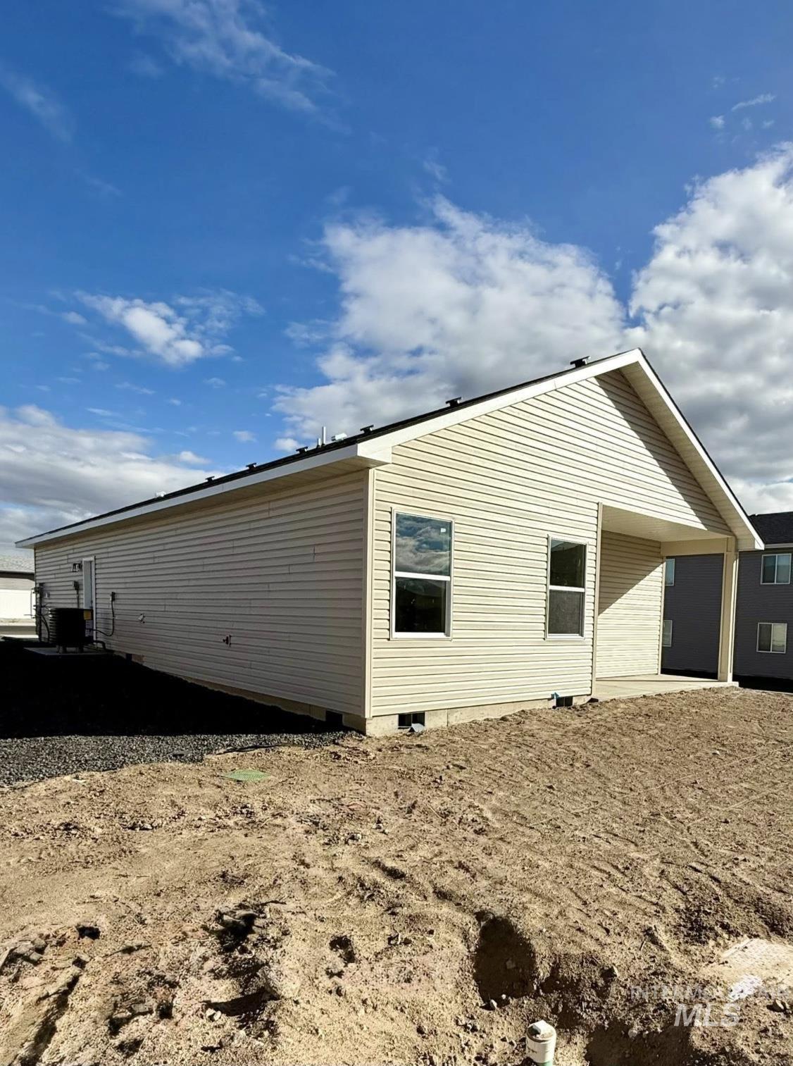 View of side of home with a cooling unit
