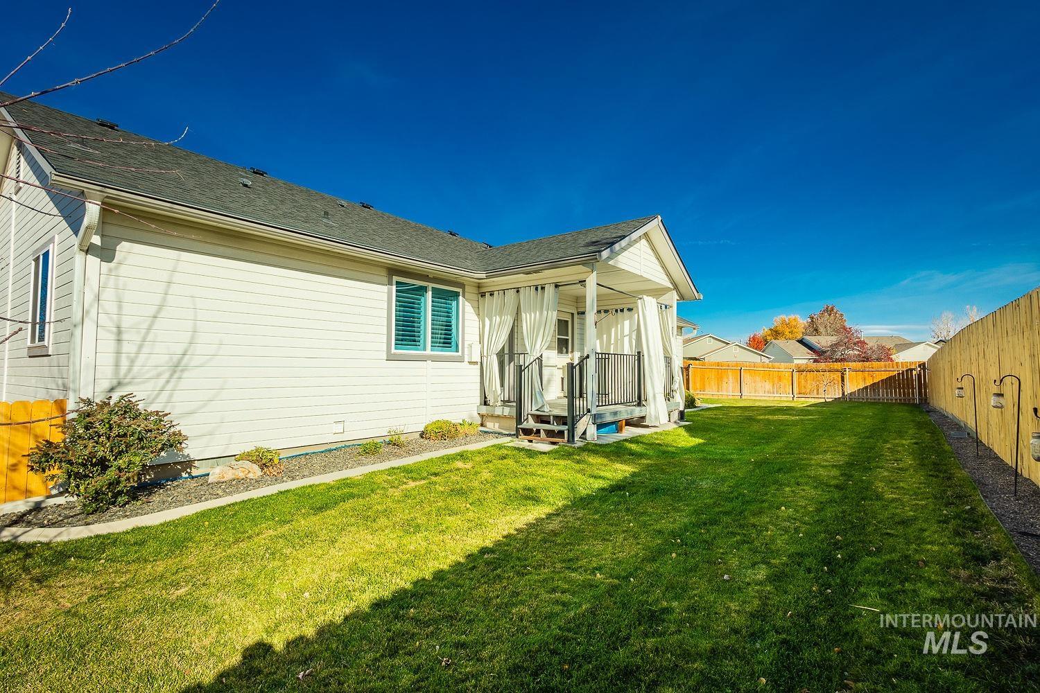 View of home's exterior featuring a fenced backyard and roof with shingles