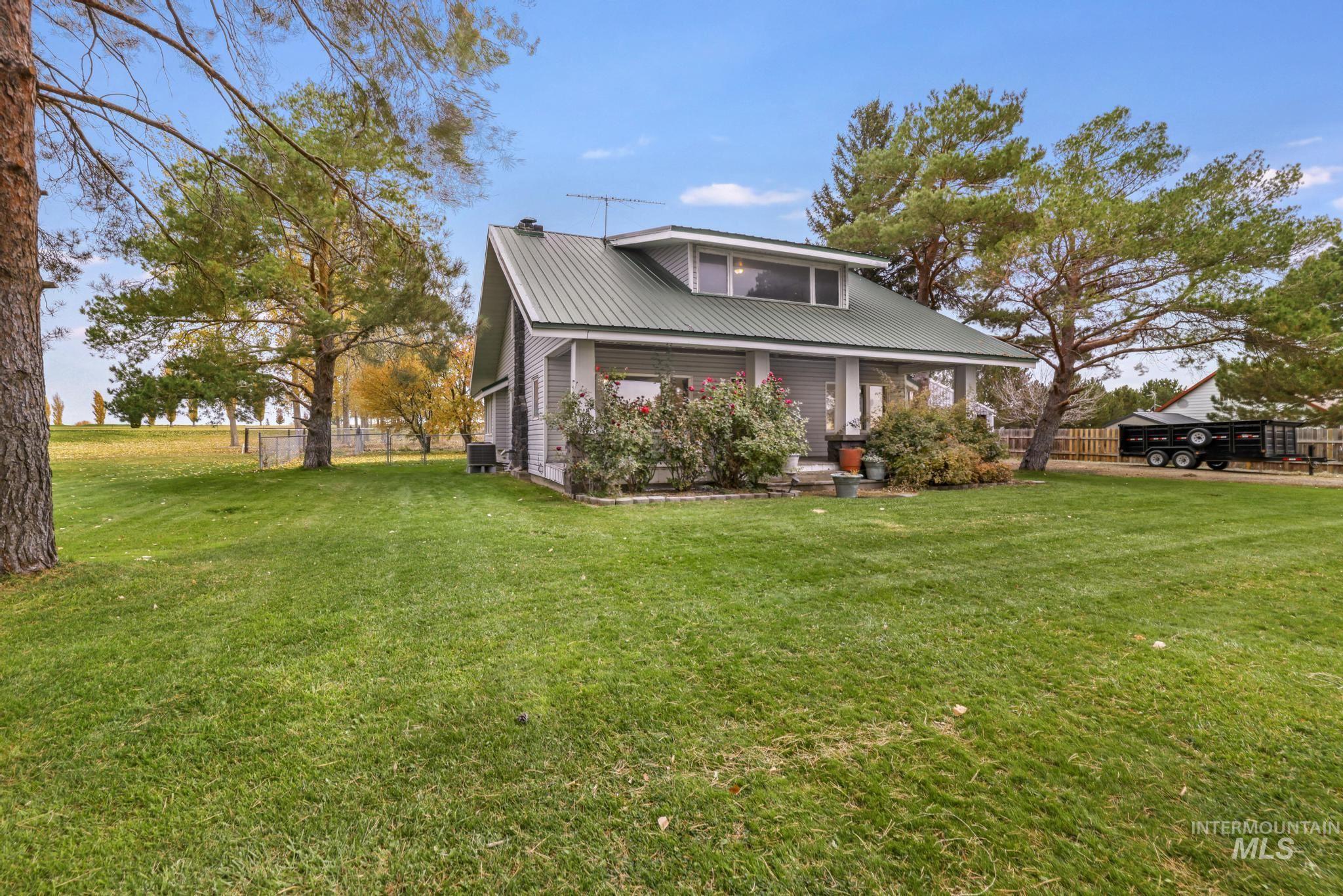 View of front of home with a metal roof and a porch