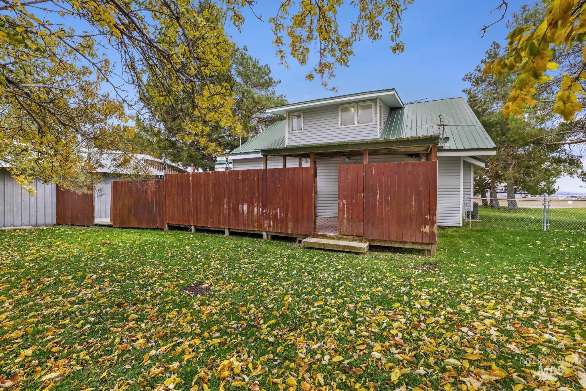 Back of property featuring a fenced backyard and a metal roof