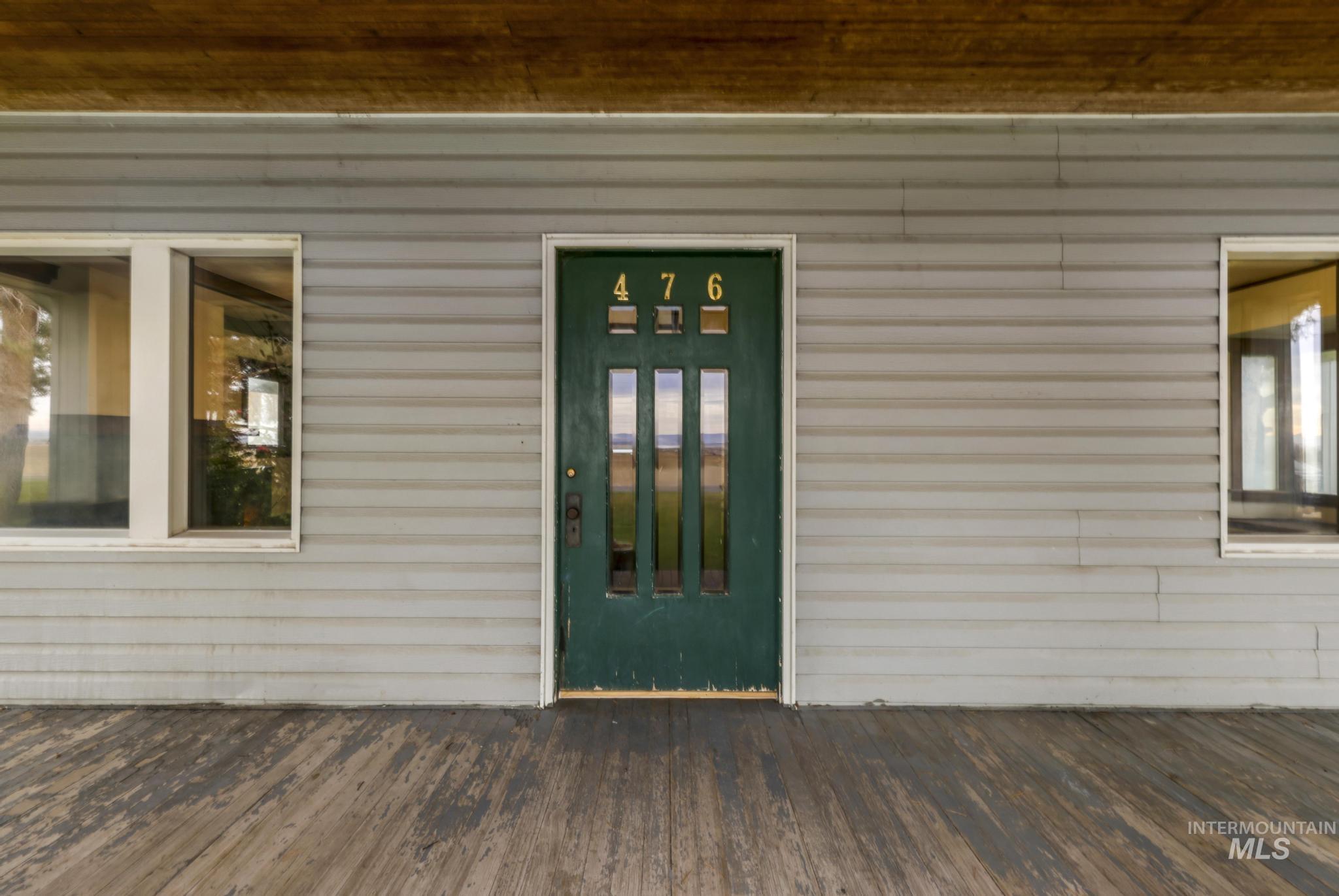 View of exterior entry with a deck