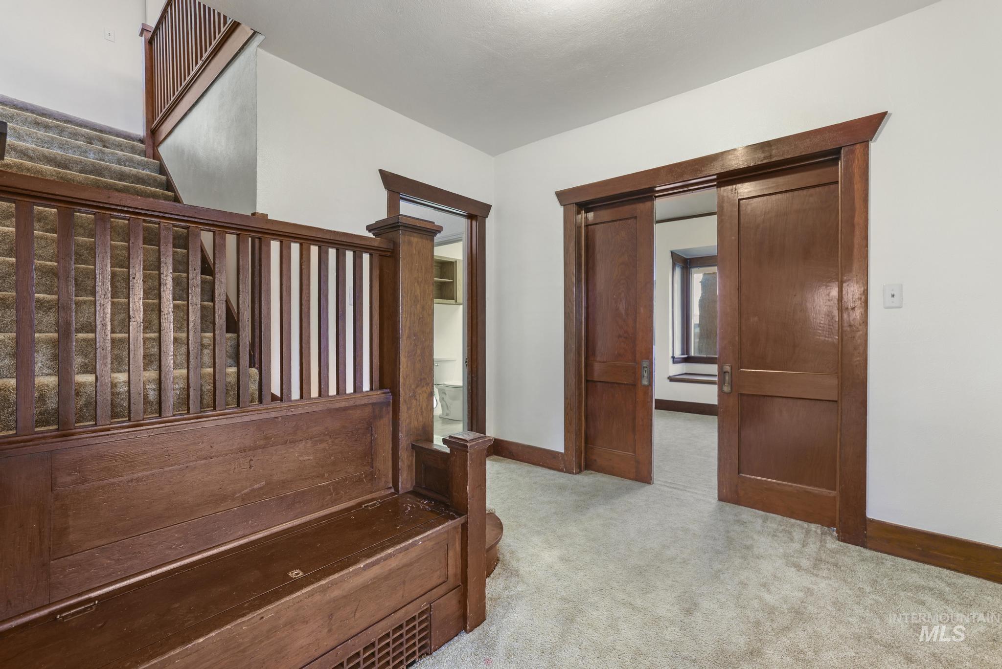 Stairway with carpet floors and baseboards