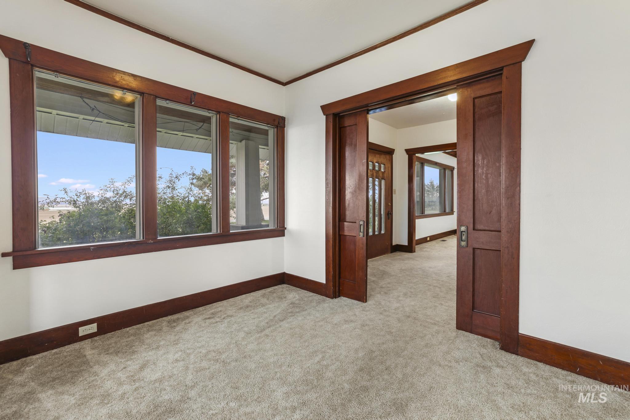Unfurnished room with light colored carpet and ornamental molding