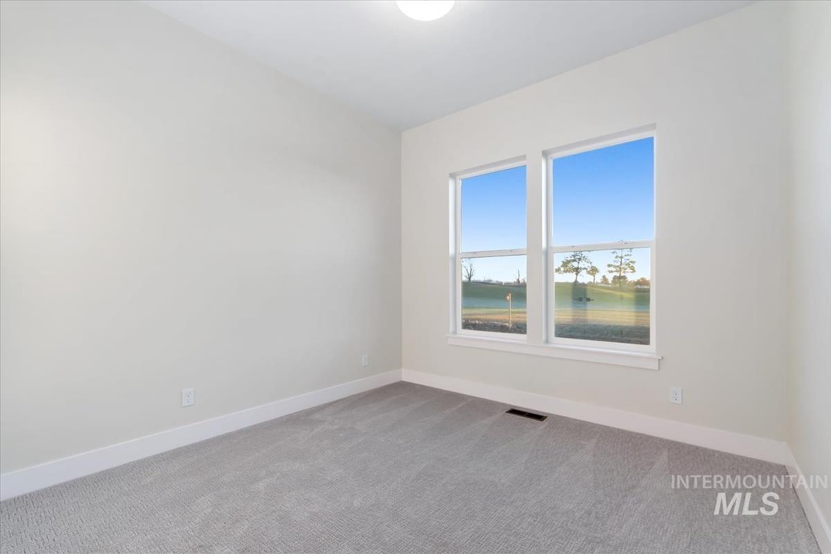 Empty room with carpet floors and a water view