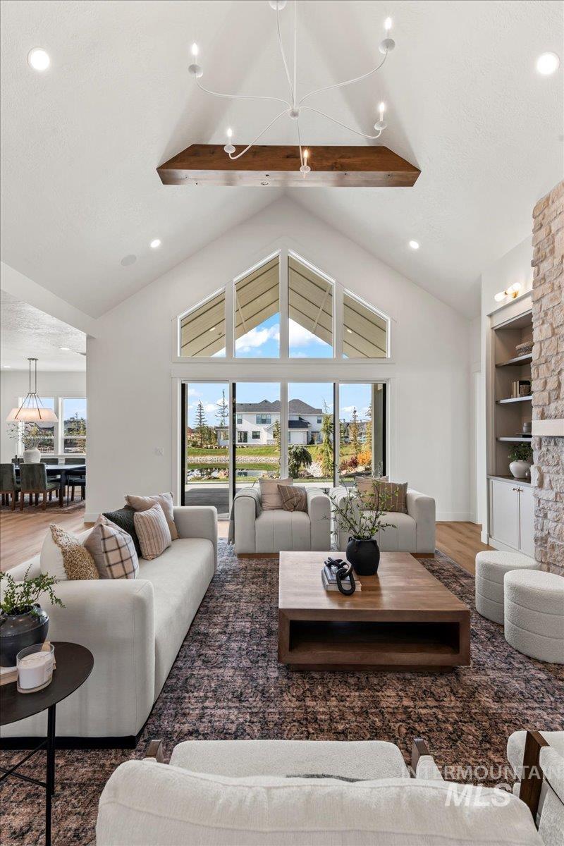 Living area featuring wood finished floors, recessed lighting, and high vaulted ceiling