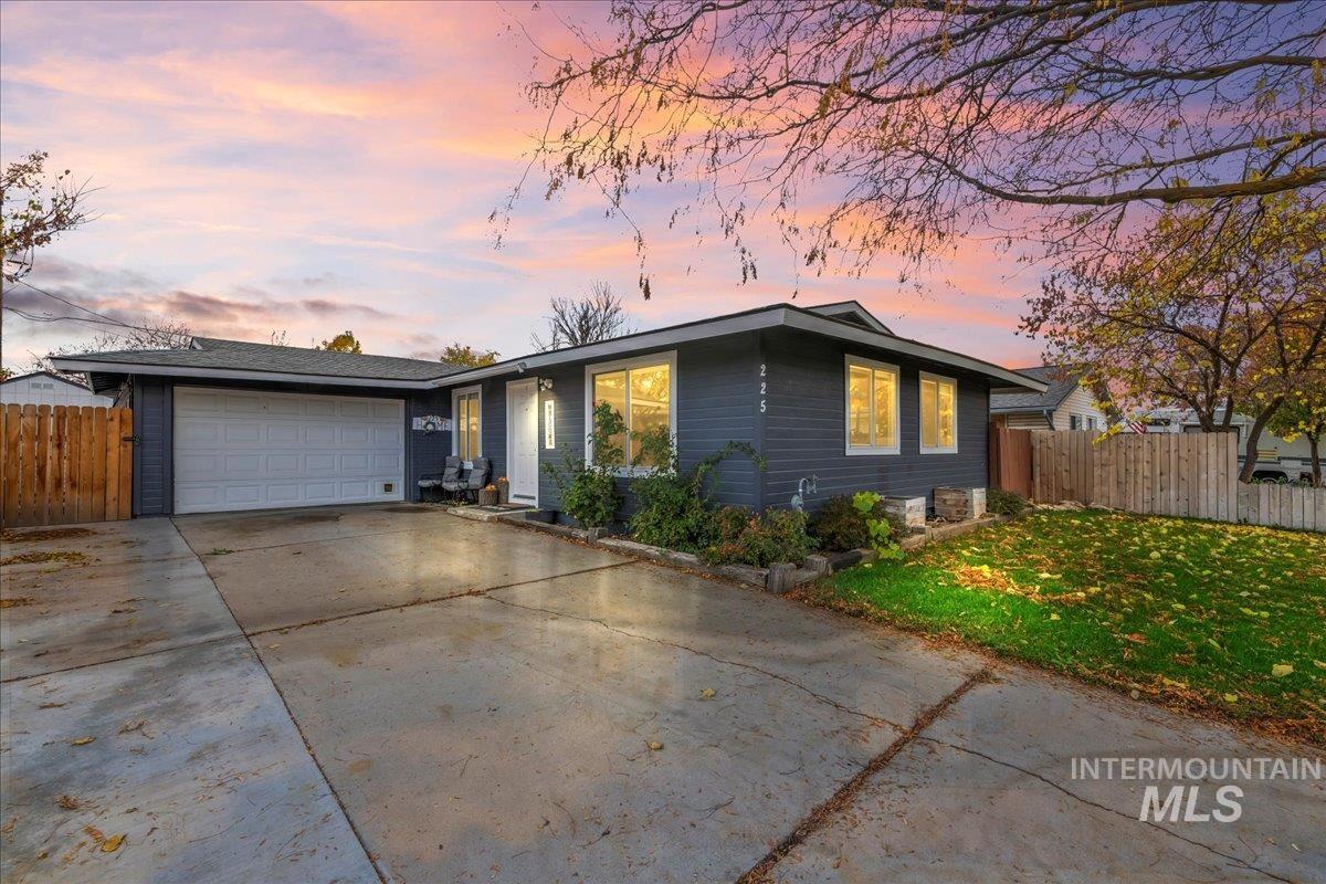 View of front of house with driveway and an attached garage
