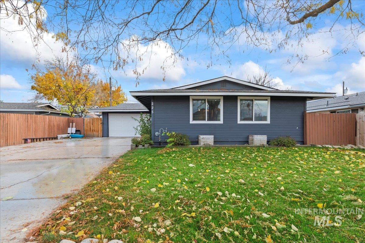 View of side of home featuring concrete driveway and a garage