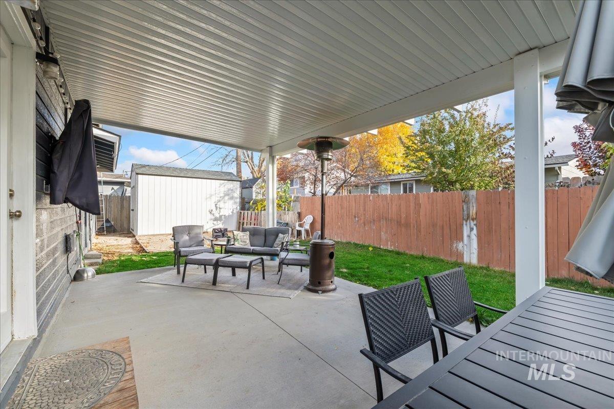 Fenced backyard with outdoor lounge area and a patio