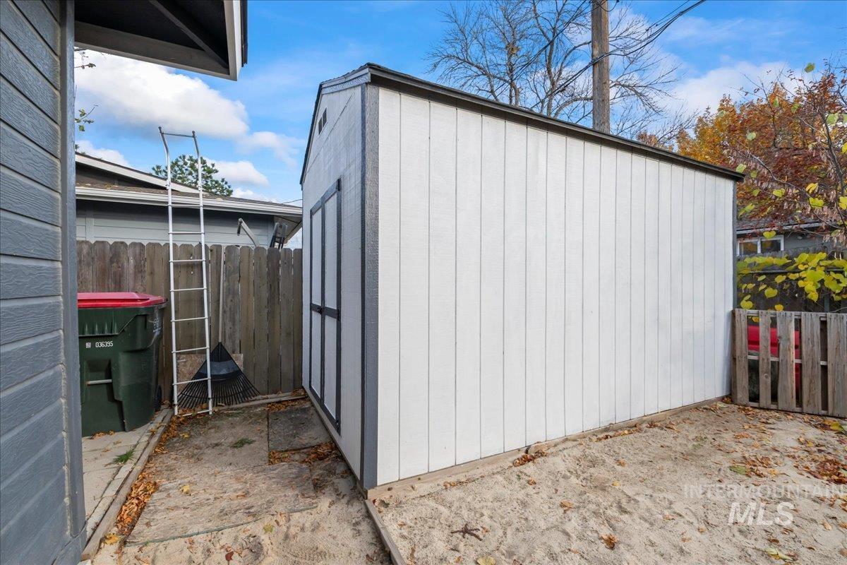 View of shed with a fenced backyard