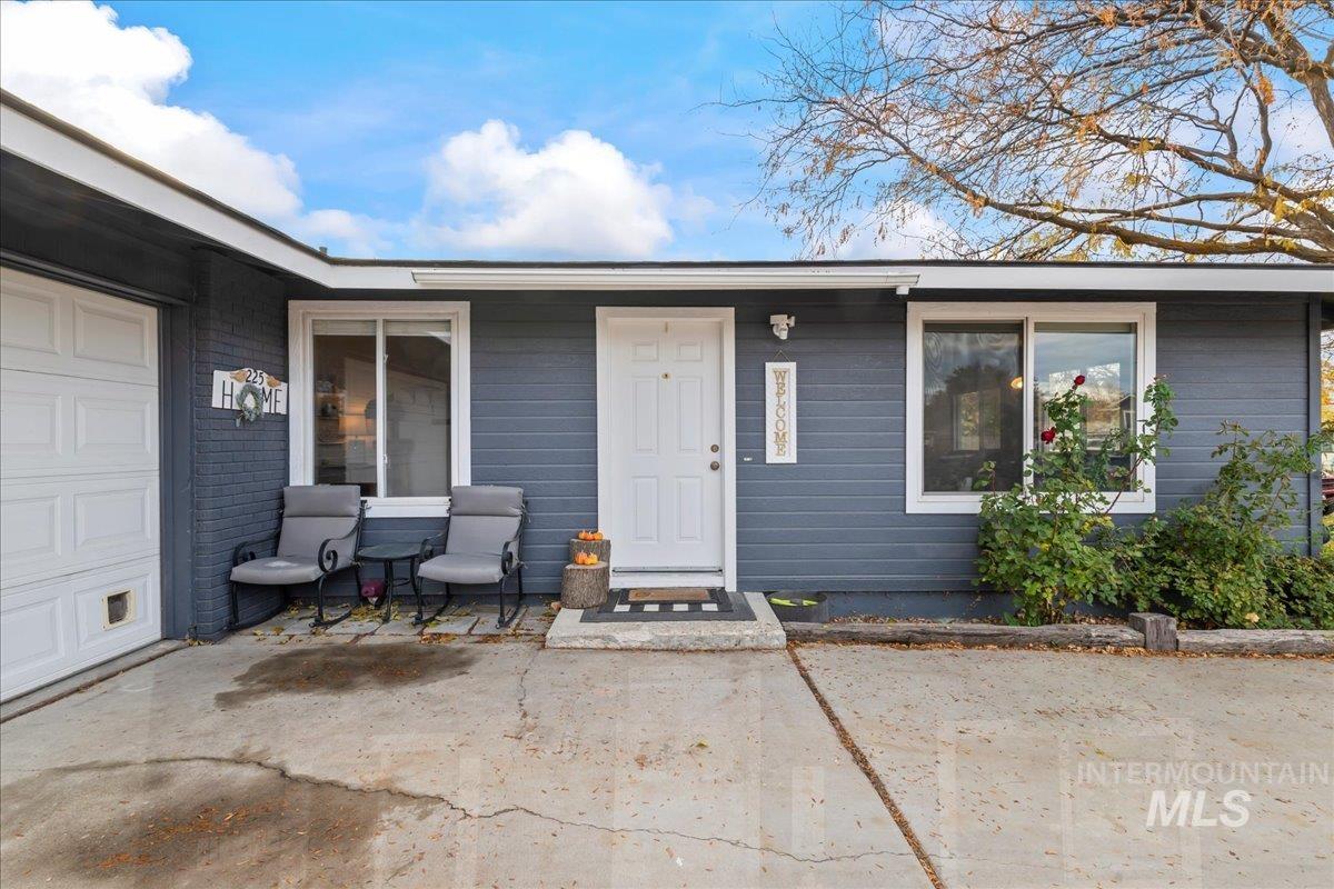 View of exterior entry with a garage