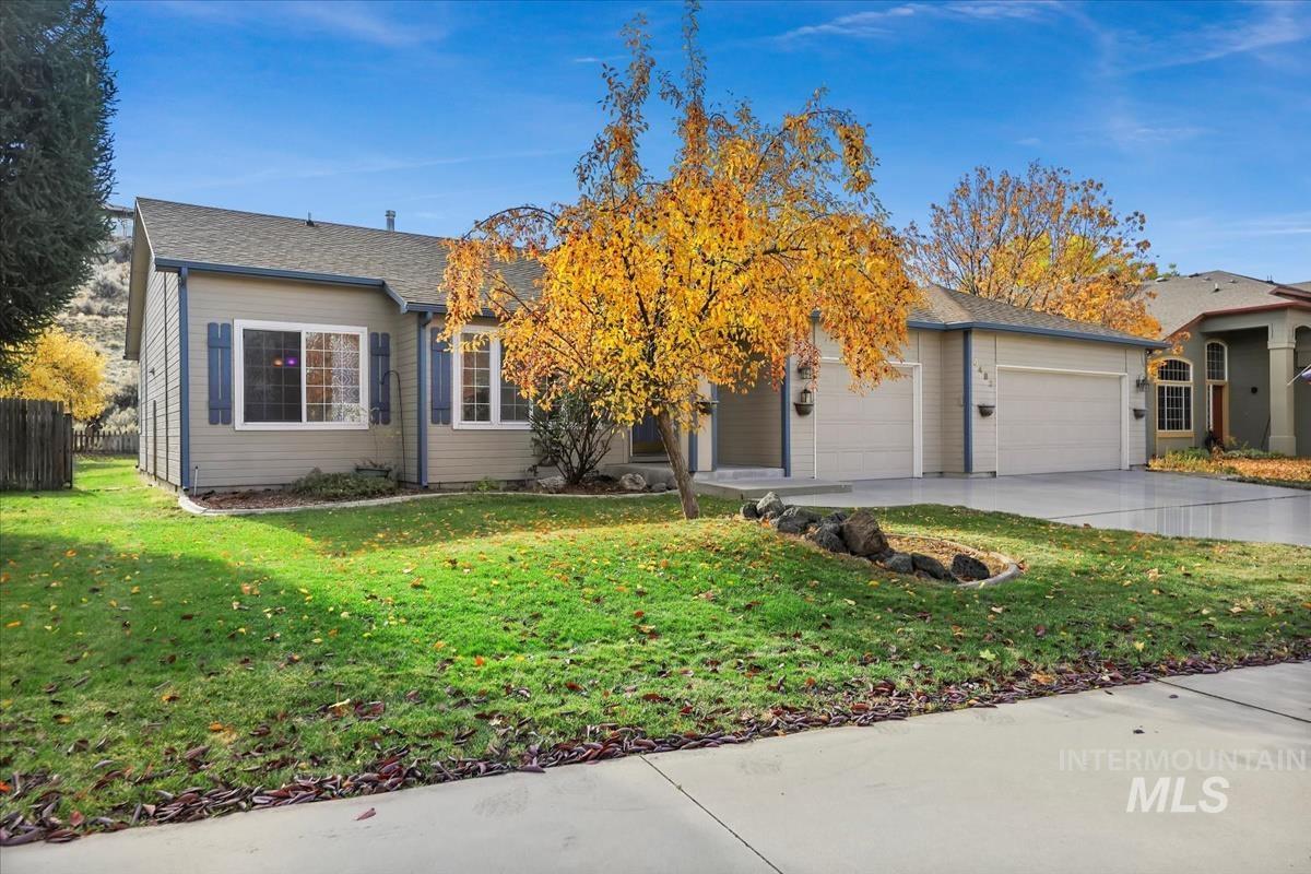 View of front of property featuring driveway and an attached garage